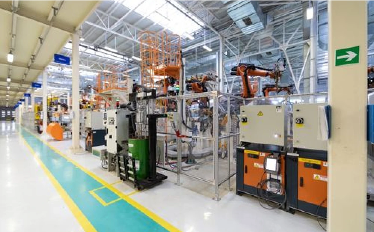 The interior of a factory with many machines and equipment.