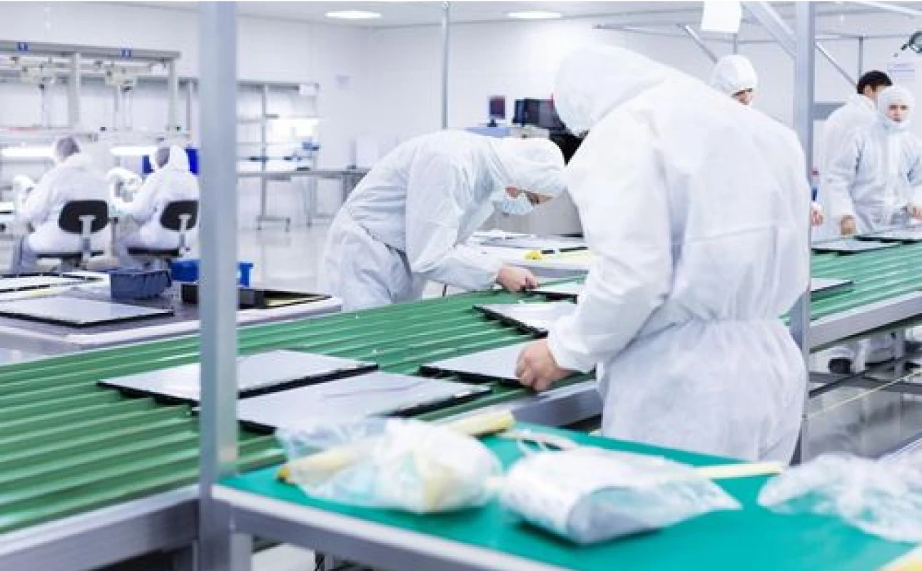 A group of people working in a factory.